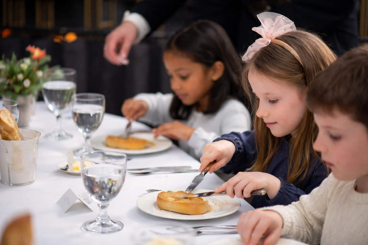 Children learning formal dining etiquette at a laid table